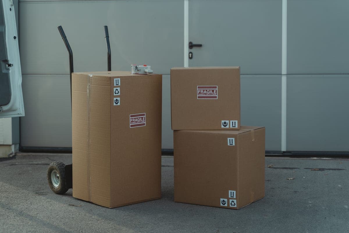 Shipping cartons stacked in a business storeroom next to a workbench