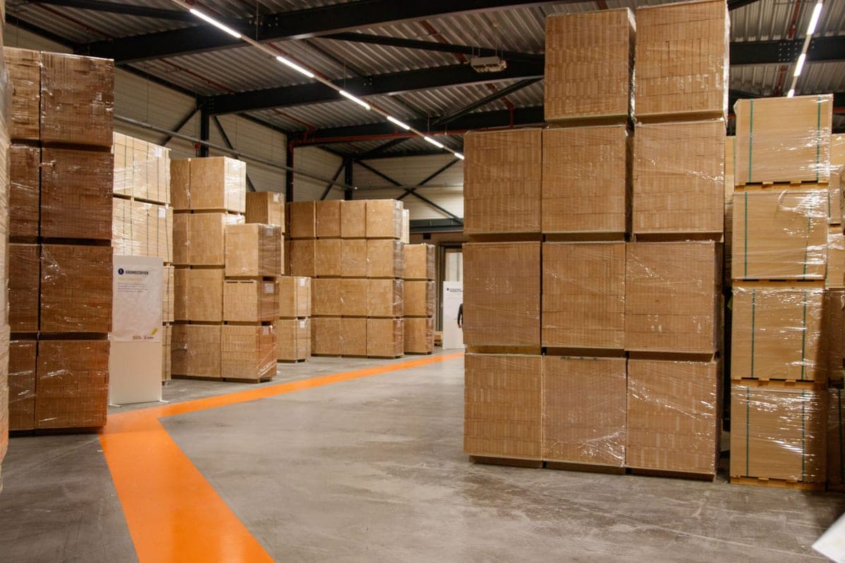 Two stacks of shipping cartons side by side in a business storeroom