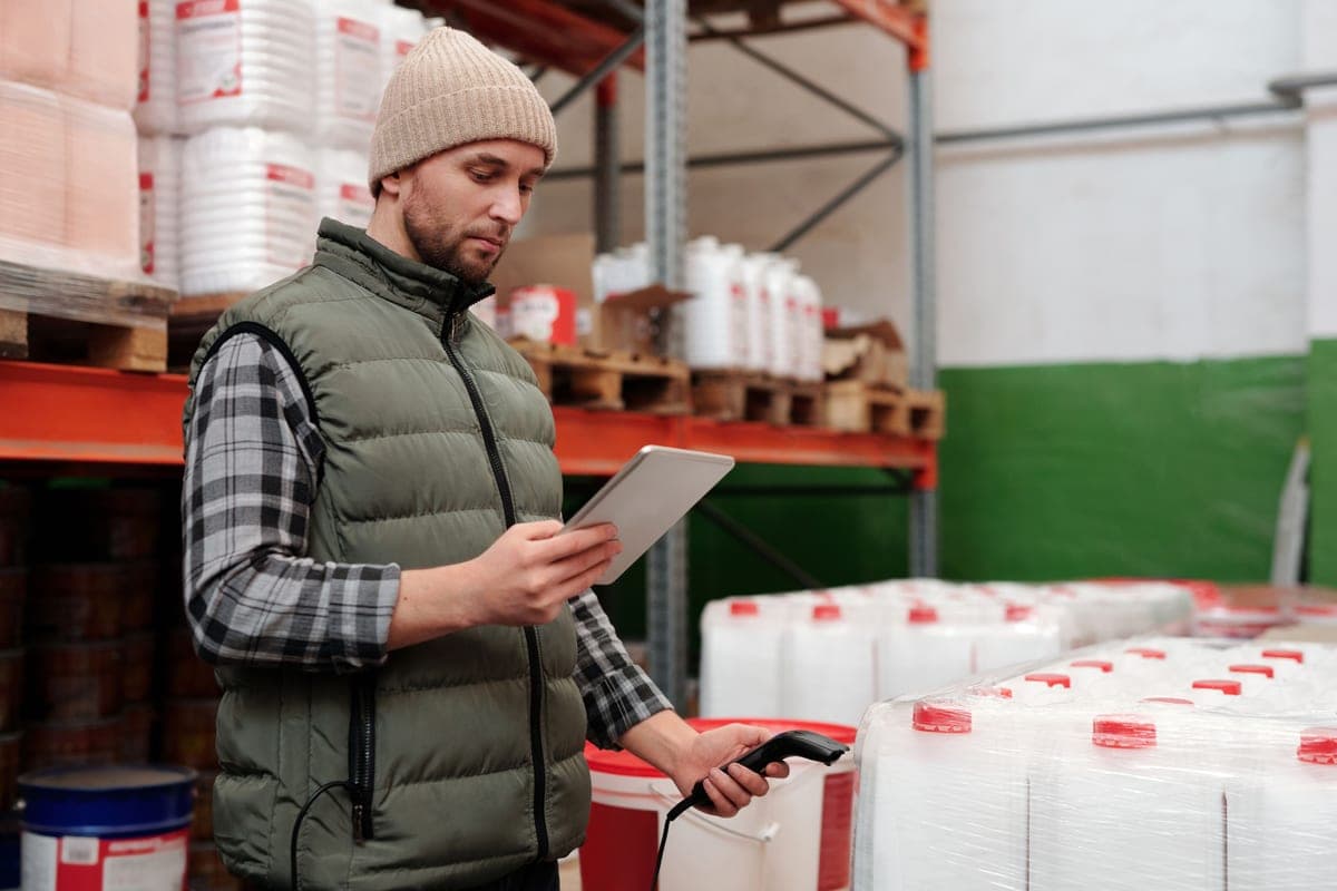Warehouse worker scanning a package with a handheld barcode reader