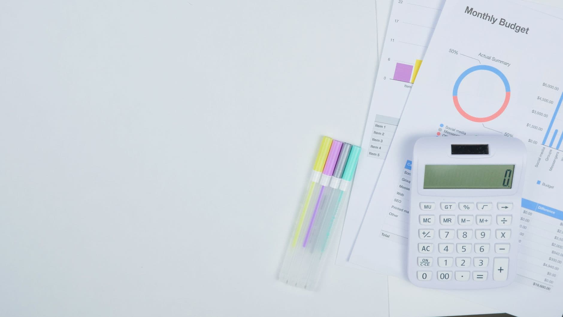 Office desk with a calculator and monthly budget planning documents