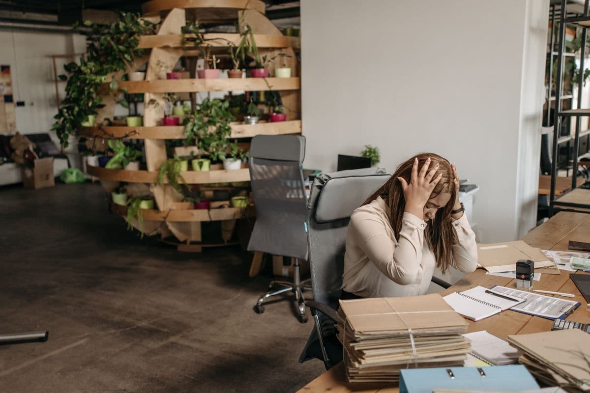Small business owner reviewing paperwork with a concerned expression