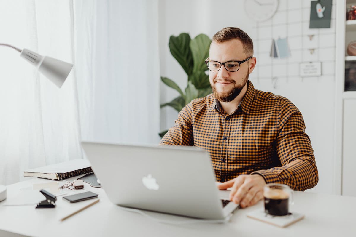 One-person business owner working at a home office desk