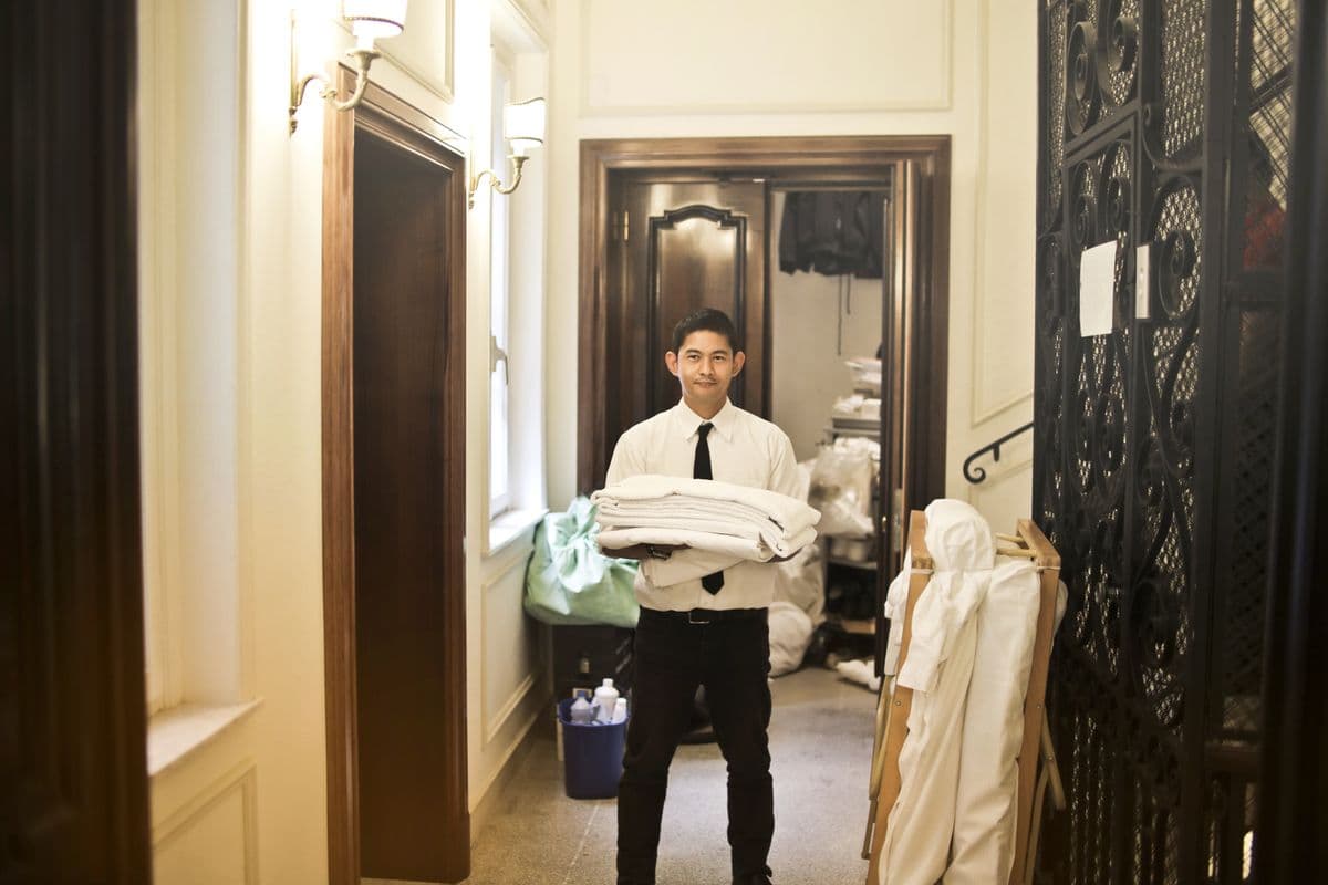 Housekeeping cart with linens in a hotel corridor