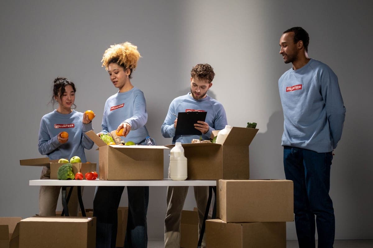 Volunteers sorting donated supplies into boxes at a community organization