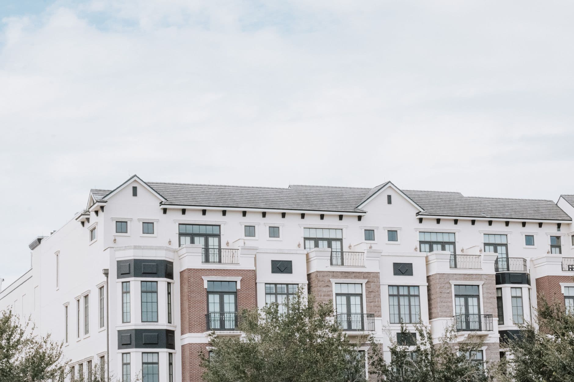 Modern multi-story apartment building against a clear sky