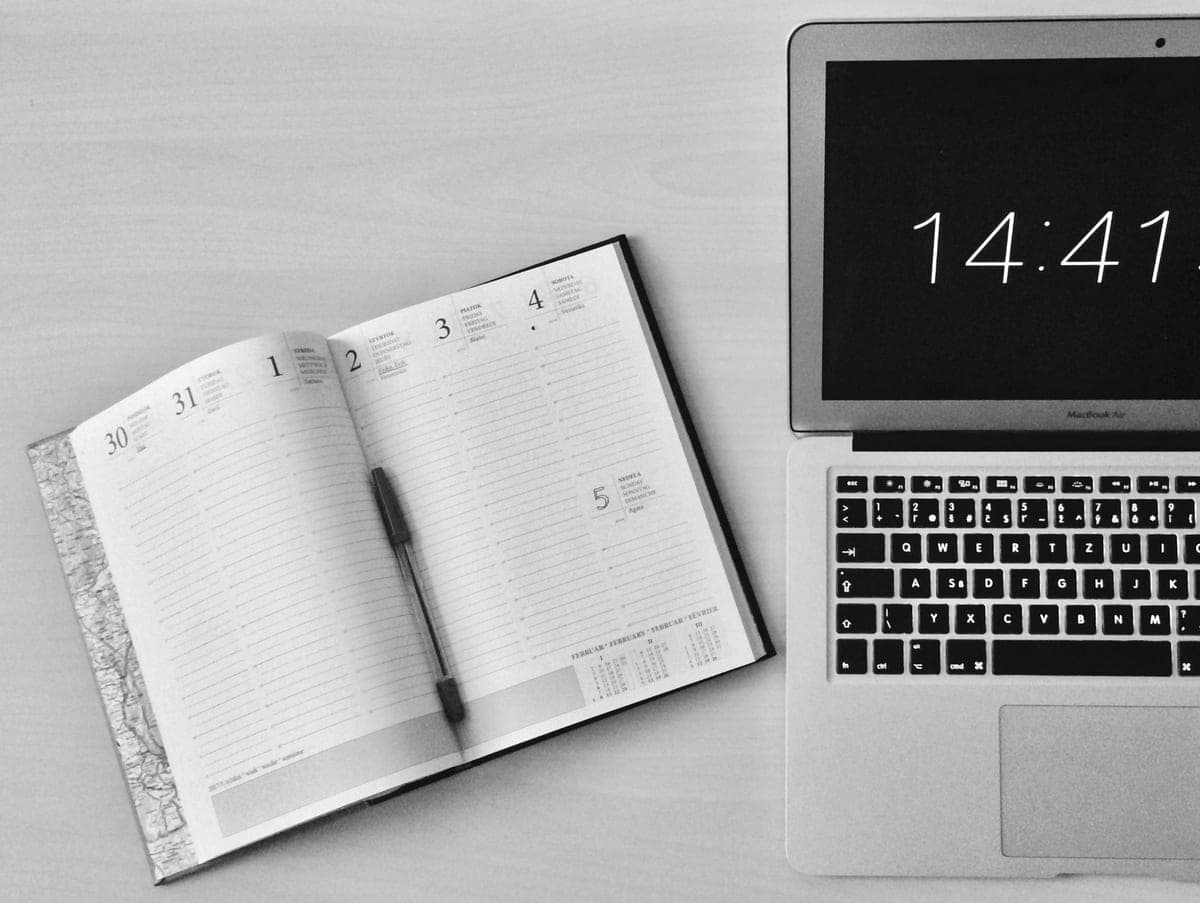 Calendar and a laptop on a desk in a small business back office