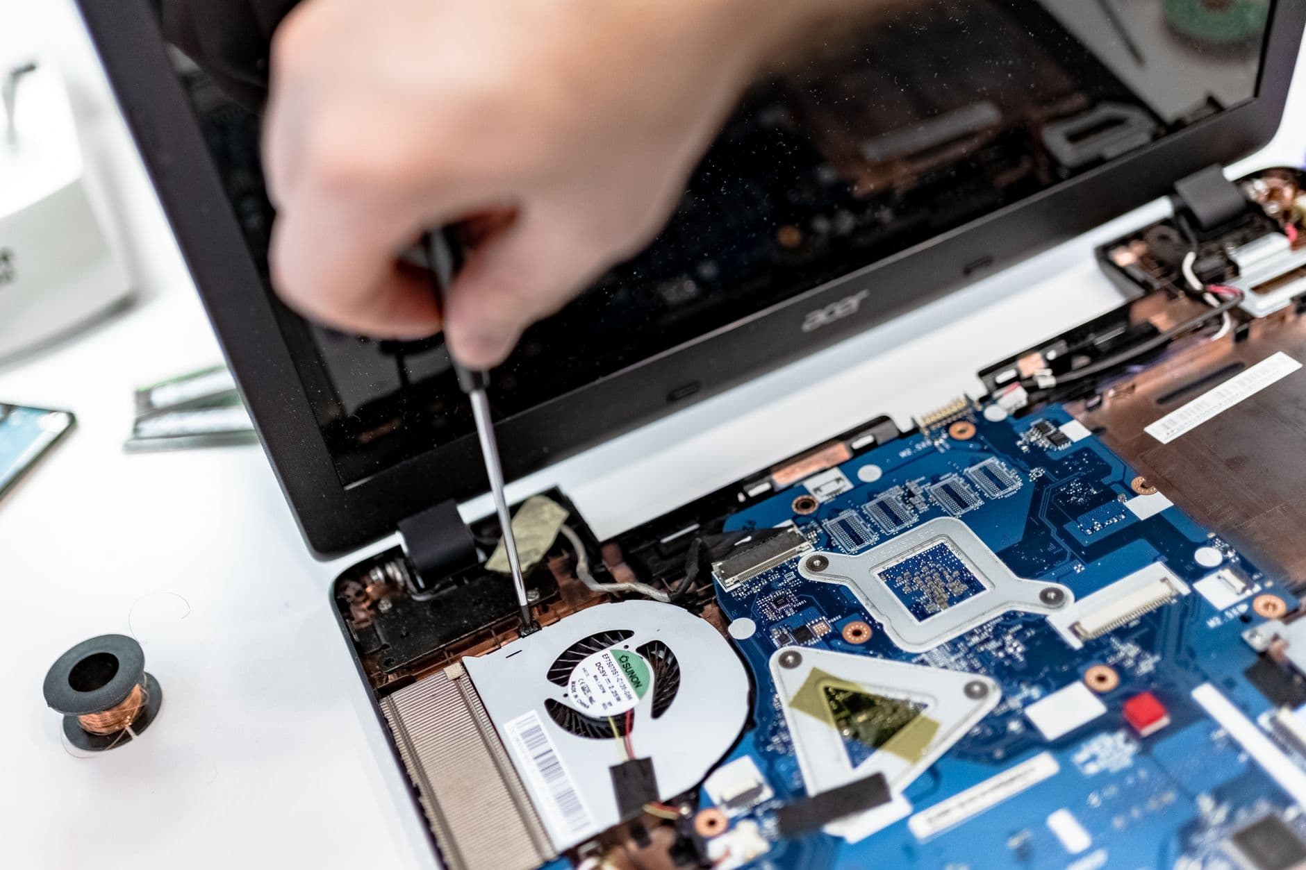 Technician working on the internal components of a laptop