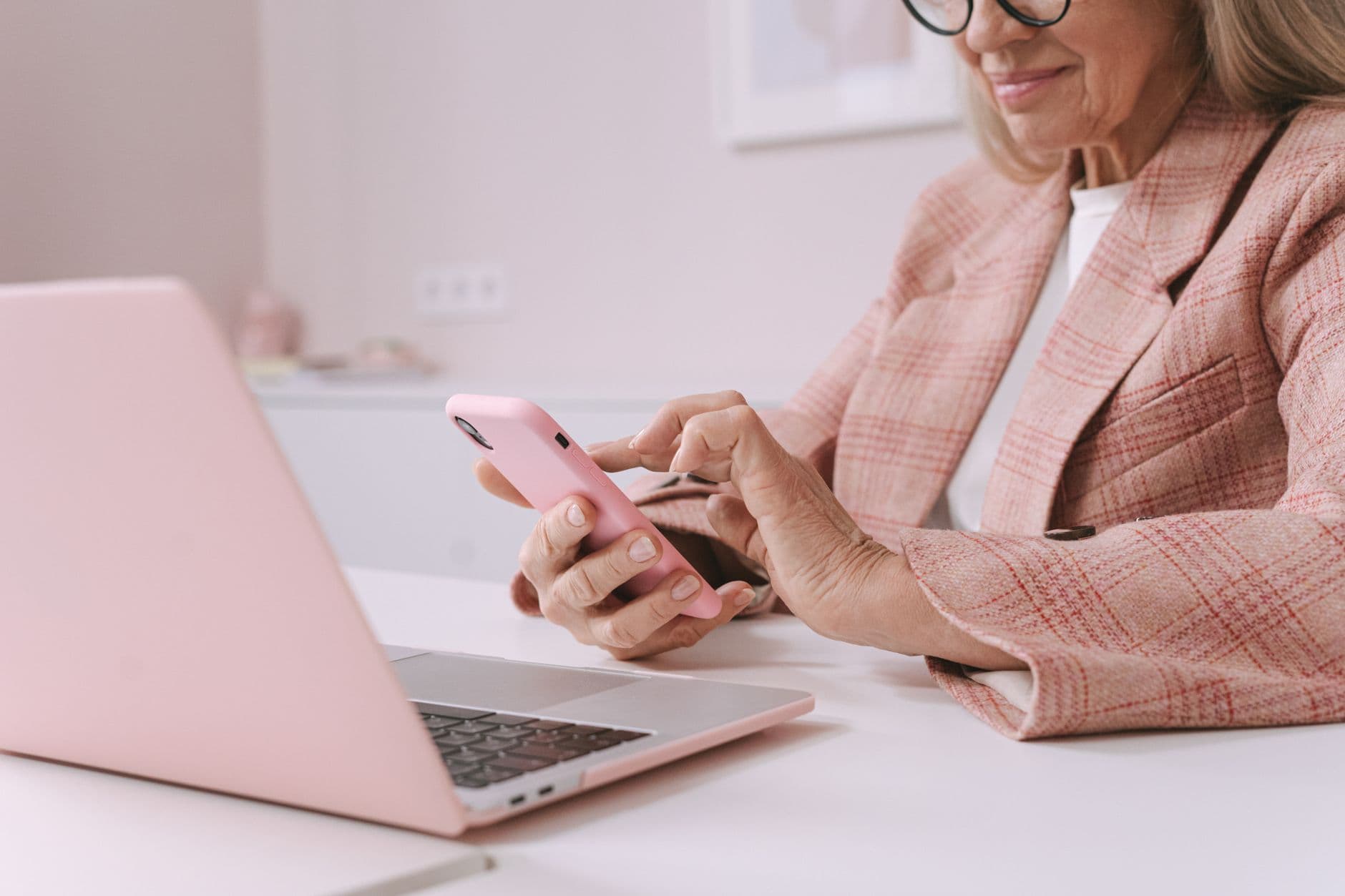 Person using a smartphone while working at an office desk