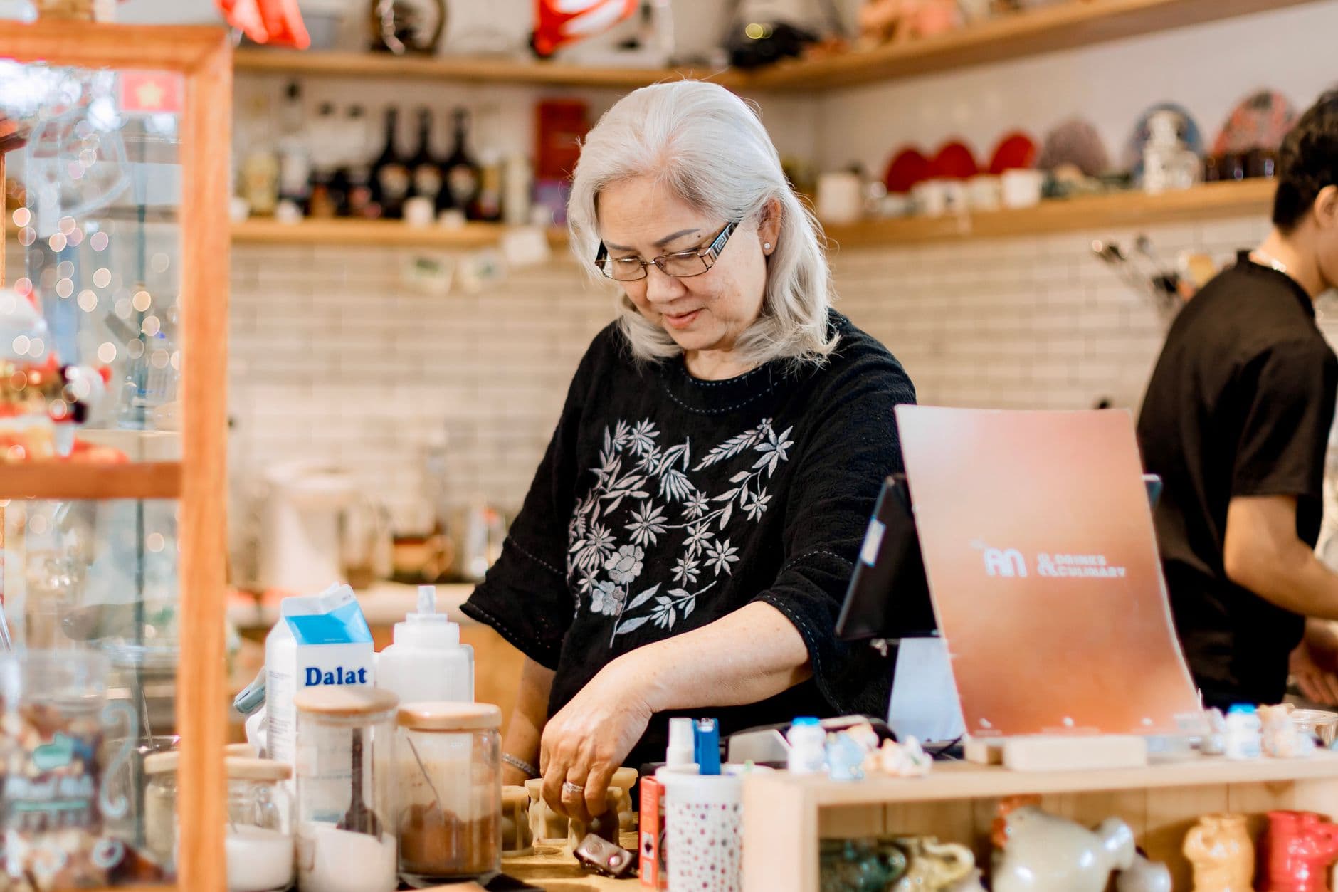 Small business owner working behind the counter of a local shop