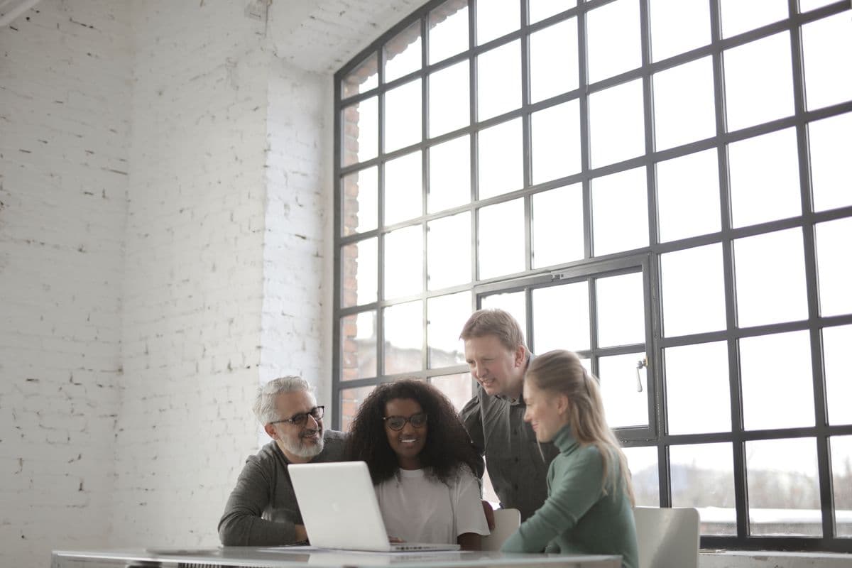 Colleagues setting up accounts together on a laptop