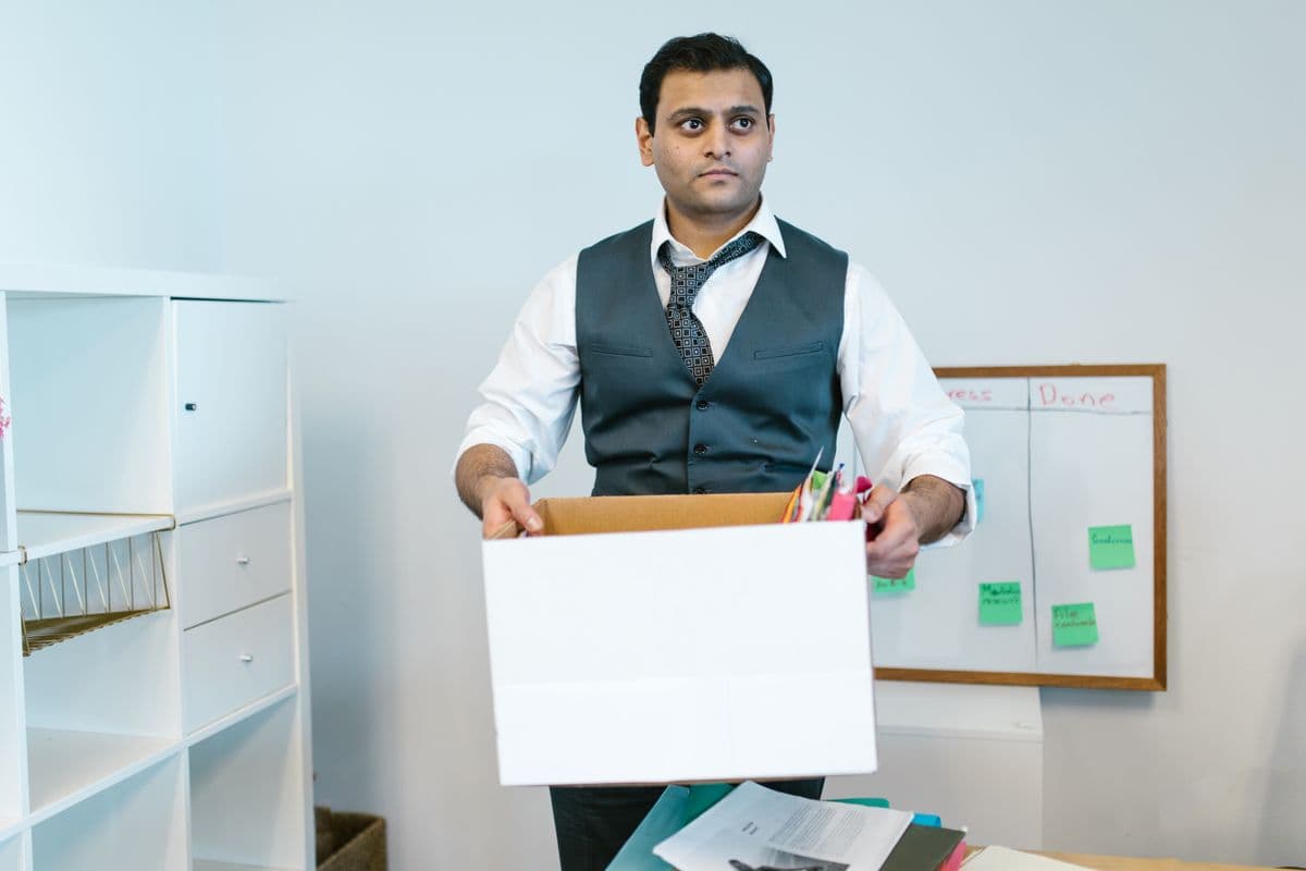 Tidy desk with a packing box in an office being cleared