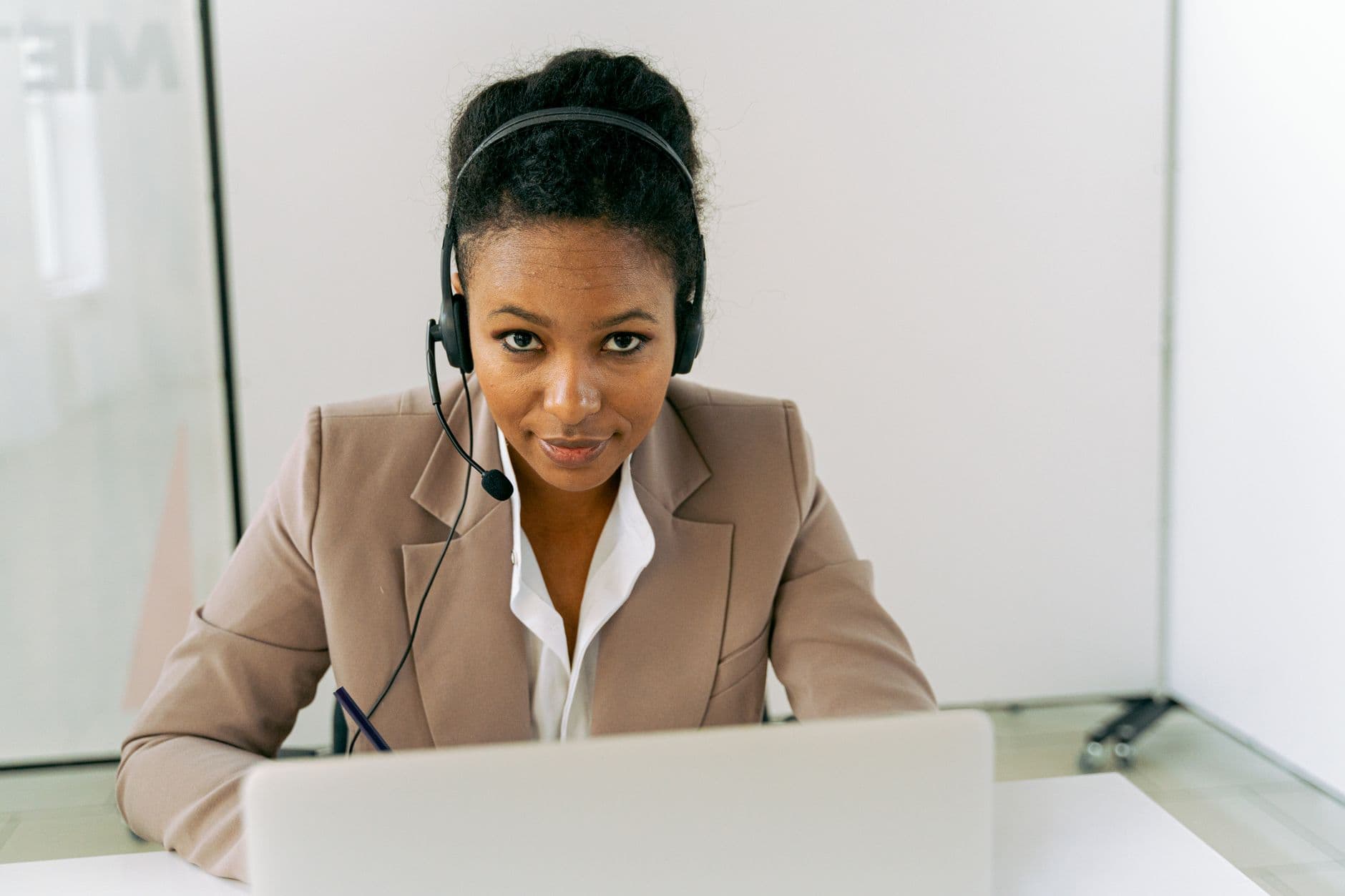 Customer service agent wearing a headset at a support desk