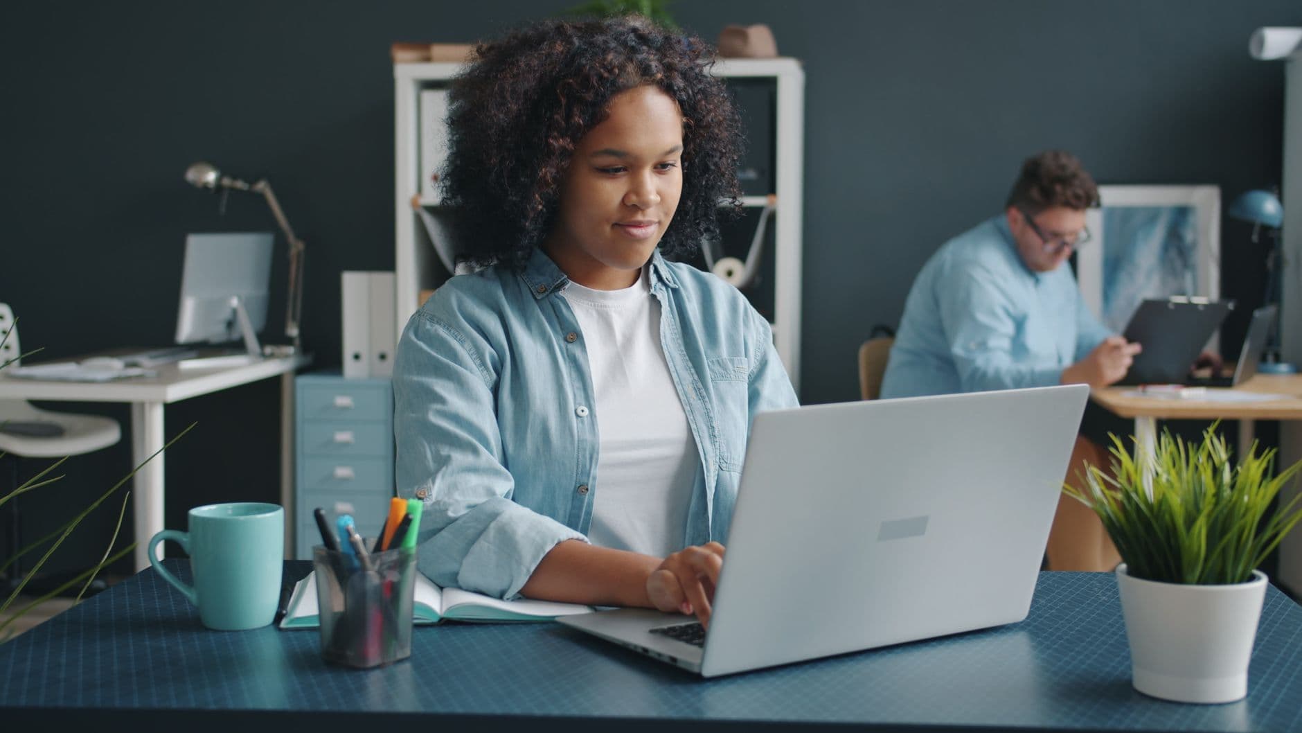 New employee working at a laptop in a contemporary office
