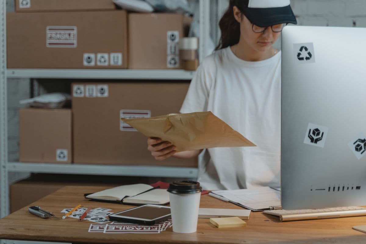 Office worker unpacking a delivery box at a desk