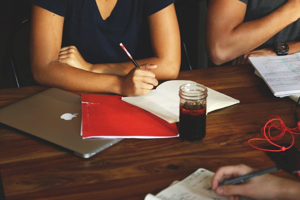Team meeting around a table with laptops in a small business office
