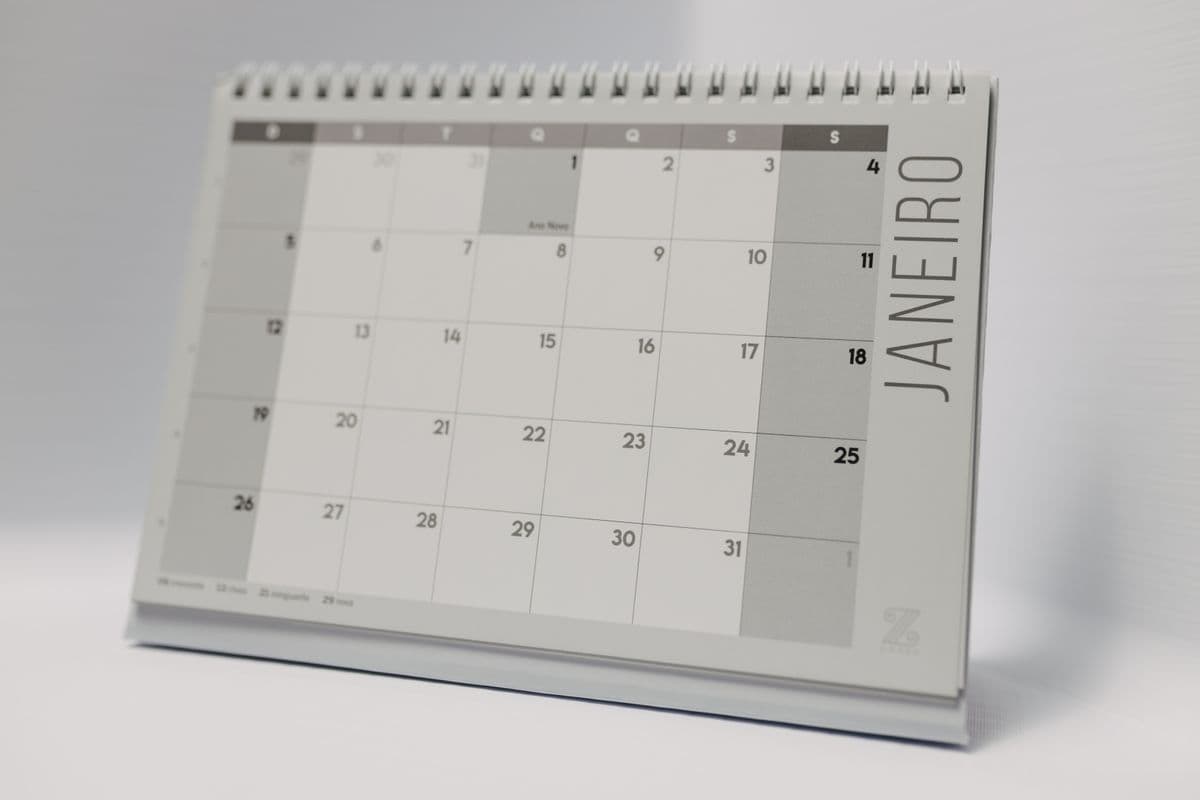 Wall calendar and planner on a business office desk