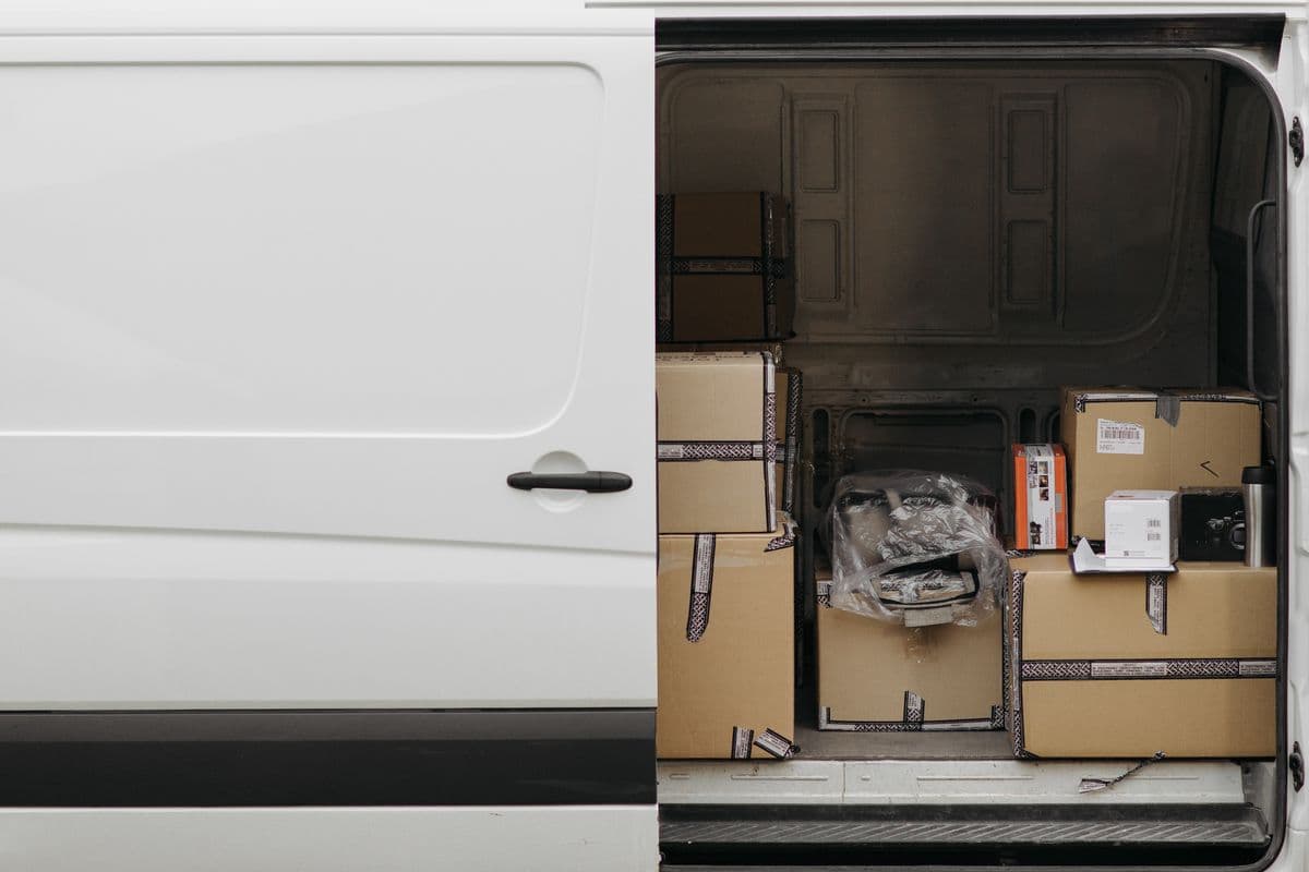 Delivery van being loaded with parcels for a business drop