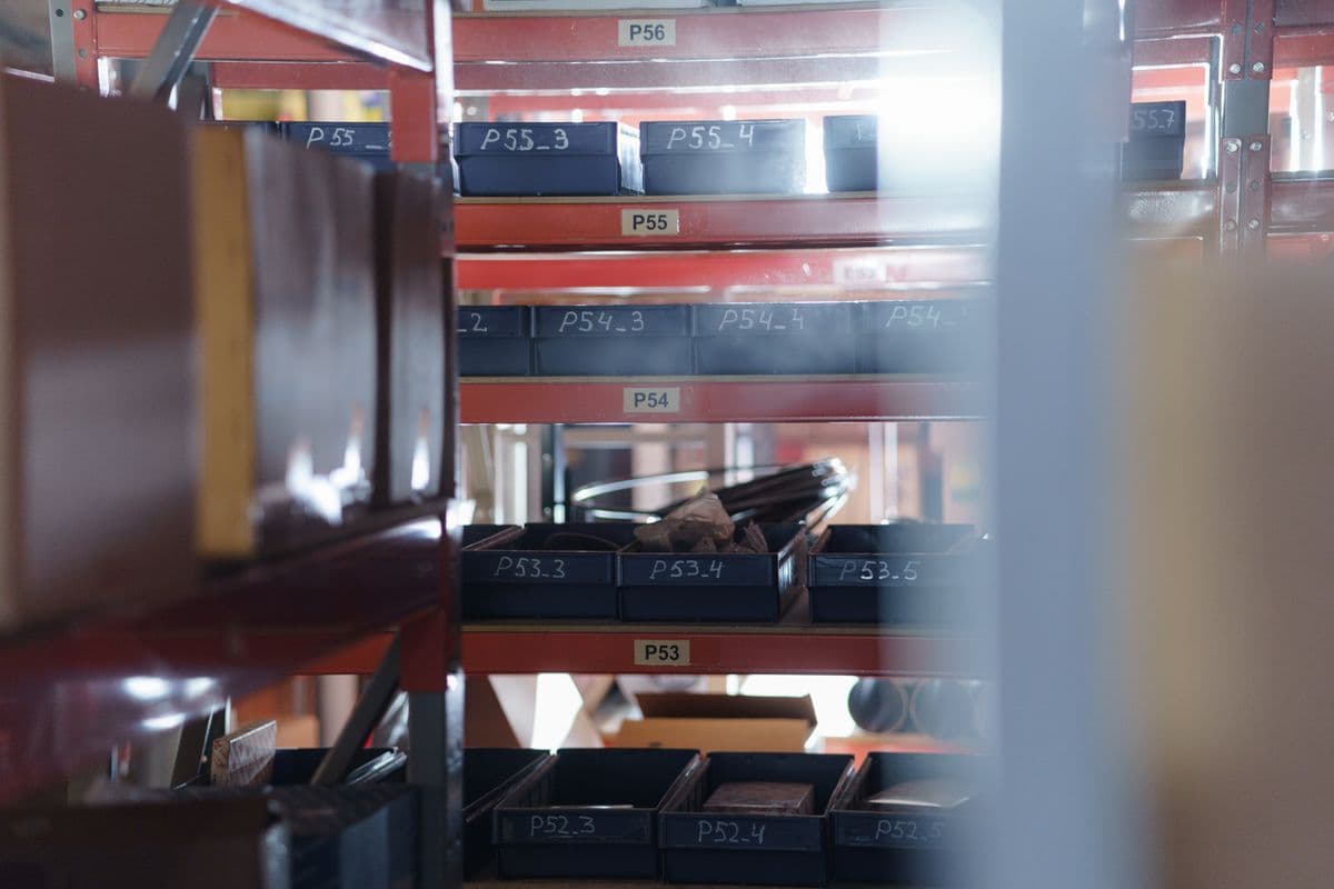 Worker restocking supply shelves in a stockroom