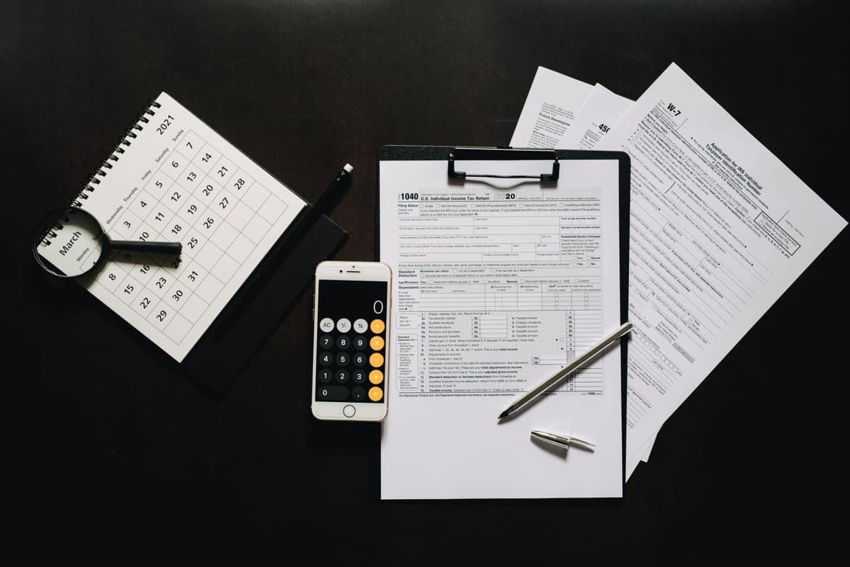 Tax forms and a calculator on a desk in a small business office
