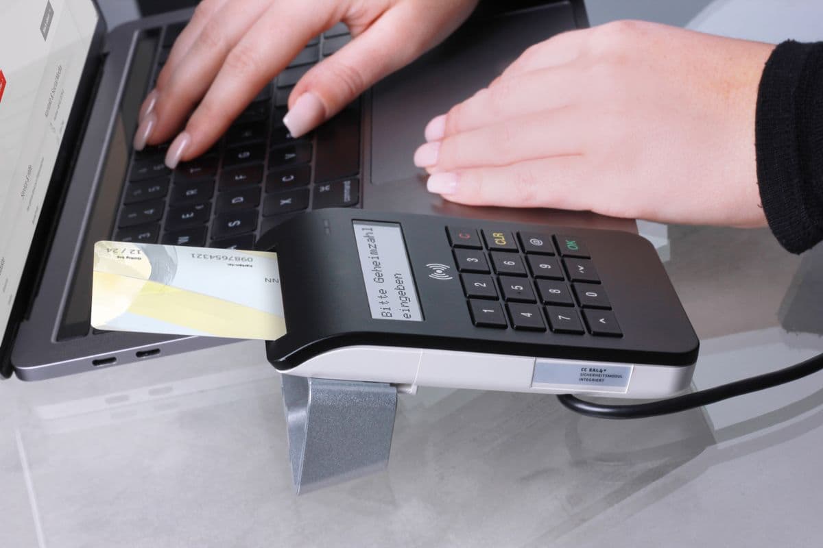 Business credit card beside a card terminal on a counter