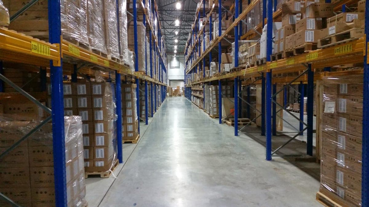 Warehouse aisle with pallets of stock ready for business orders